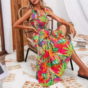 Tropical leaf print maxi dress in vibrant pink with bow straps and pleated bodice