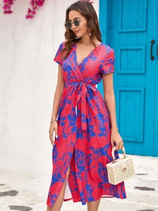 Detailed V-neck and waist tie of a blue floral summer dress in a Mediterranean setting