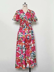 Detailed view of floral print V-neck dress featuring ruffle sleeves and waist tie detail