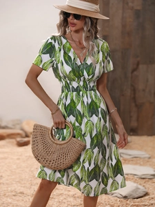 Detail of tropical leaf print summer dress with V-neckline and elastic waist for women