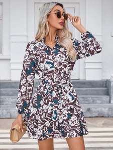 Detailed view of floral long sleeve dress with button-down front and waist belt