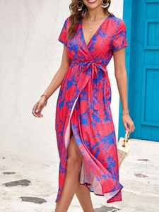 Detailed view of the V-neckline and red blue floral print on the summer wrap dress
