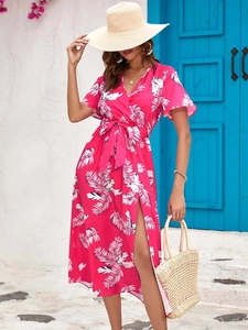 Detail of tropical palm print midi dress with side slit and waist tie in rose pink color