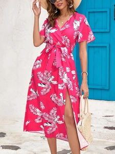 Detail of tropical feather print dress featuring side slit and stylish wrap waist tie