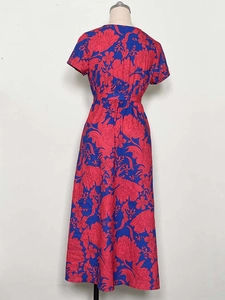 Detailed view of women's V-neck printed dress with floral pattern and belted waistline