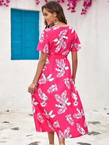 Detail of fuchsia summer dress with white palm leaf print and waist tie belt