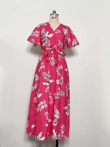 Detailed view of the fuchsia tropical palm leaf print and drawstring waist on the dress
