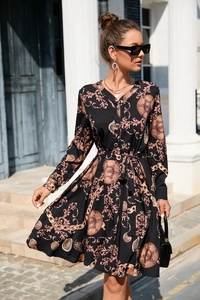 Detailed view of long sleeve V-neck dress with baroque print and gold button closure