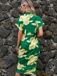 Detail view of the floral print pattern and back waist structure on a green summer dress