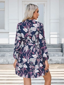 Detail of navy long sleeve dress with tropical leaf print and elegant back view