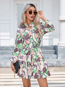 Detail of floral print shirt dress with waist tie and tropical plant pattern