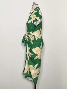 Detail view of dark green floral mini dress with shirt collar and waist tie design