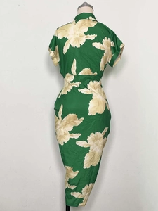 Detailed back view of a slim-fit green floral print midi dress with short sleeves and waist tie