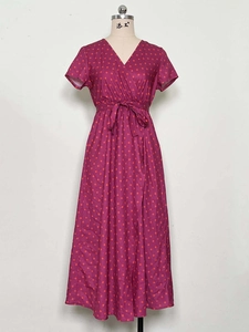 Detail showing V-neckline and orange polka dot pattern on purple summer maxi dress