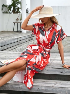 Detail of red tropical leaf print dress with button-down front and waist tie