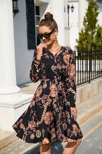 Detailed close-up of a vintage print maxi dress with baroque patterns and waist belt