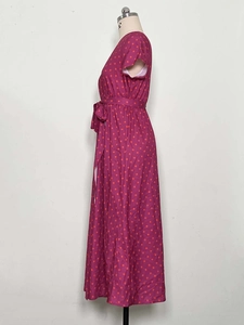 Detail view of the side-tie waist and polka dot pattern on the pink summer dress