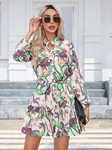 Detail of tropical floral print shirt dress with button-up collar and ruffled hemline