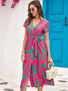 Close-up of floral V-neck maxi dress with waist tie and vibrant summer print pattern