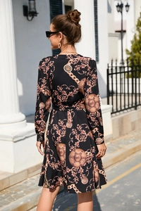 Detail of baroque gold print on long sleeve black maxi dress with waist belt