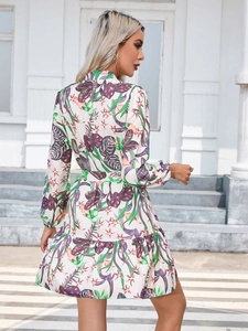 Close-up of tropical leaf print and layered ruffle hem on floral long sleeve dress