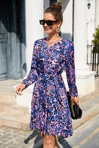 Detail of leopard print dress with V-neckline, button closure and waist tie belt