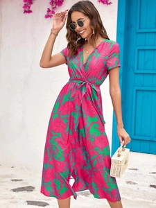 Detail of the vibrant V-neck wrap dress featuring a tropical floral print and waist tie design
