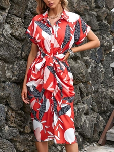 Close-up of tropical leaf pattern and drawstring waist on the red summer shirt dress