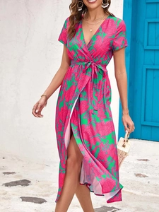 Detail of V-neck floral wrap midi dress with side slit and waist tie in vibrant print