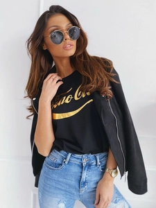 Detail of slim-fit black faux suede jacket over a Ciao Bella graphic tee and ripped jeans