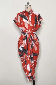 Detail of red shirt dress with black leaf print featuring lapel and button closure