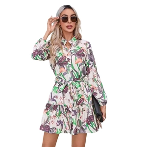 Women's tropical floral shirt dress with long sleeves and belted waist on white background