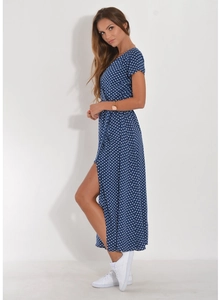 Detail view of navy blue polka dot dress featuring a high side slit and V-neckline cut