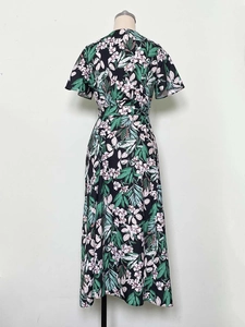 Detail view of the floral print pattern and waist tie on the black summer maxi dress