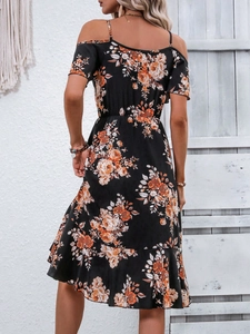 Detail of bohemian black floral dress back with orange flower print and ruffle hemline