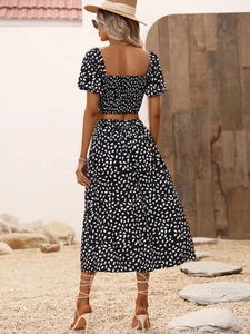 Detail of polka dot crop top with smocked back and matching high waist long skirt