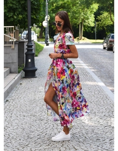Detail of colorful floral print and stylish side slit on a summer V-neck midi dress