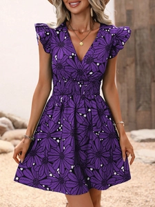 Détail de robe d'été col en V avec imprimé floral violet et taille smockée à volants
