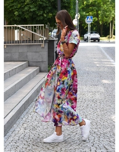 Detail of floral V-neck midi dress with side slit and waist tie in vibrant print