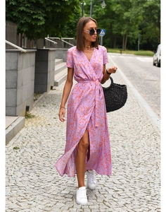 Detail of purple wrap dress with orange abstract print, deep V-neck and waist tie