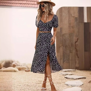 Summer two-piece set featuring puff sleeve crop top and high slit skirt with white polka dots