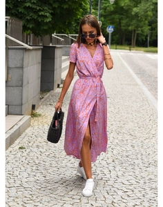 Detail of floral wrap dress with V-neckline and waist tie, featuring orange patterns