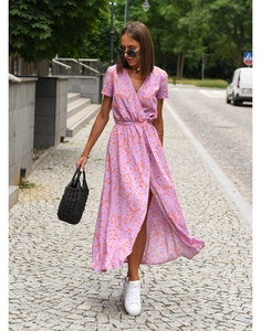 Detail of lavender floral wrap dress with deep V-neck and high side slit in street style