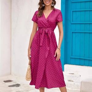 Summer V-neck polka dot midi dress with waist tie and side split on a model