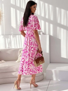 Detail of pink and white swirl pattern on a V-neck midi dress with ruffled short sleeves