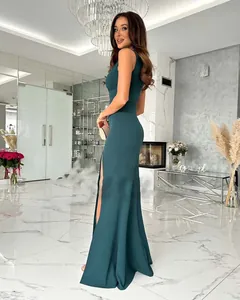 Detail view of the side slit on a sleek dark green sleeveless V-neck evening gown