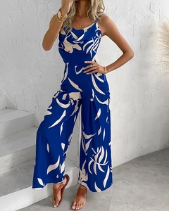 Detail of blue floral jumpsuit featuring a cowl neck and wide leg fit in a resort style