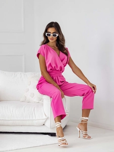 Detail of rose pink V-neck short sleeve jumpsuit with waist belt and draped fabric