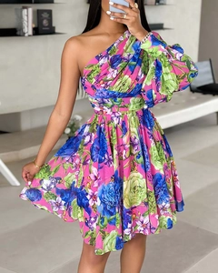 Détail d'une robe fleurie bohème à une épaule avec des motifs roses et bleus éclatants