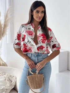 Detailed close-up of floral print shirt with five-point sleeves and button-down front